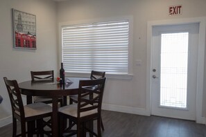 Enjoy meals in this cozy dining area with a round table and comfortable seating for four.