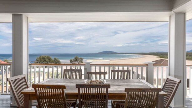 A covered outdoor dining area with a view of the beach and ocean. - Mistral, Gerroa, South Coast (Gerroa)