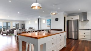 A modern kitchen with a central island, stainless steel appliances, and pendant lighting. - Mistral, Gerroa, South Coast (Gerroa)