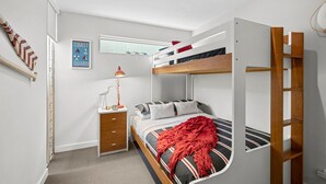 A bunk bed room with a desk, a lamp, and a poster on the wall. - A Touch Of Class (Lorne)