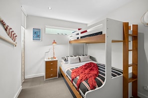 A bunk bed room with a desk, a lamp, and a poster on the wall. - A Touch Of Class (Lorne)