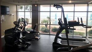 A gym with treadmills and stationary bikes, large windows with a view of the beach. - 🏖Beachfront Retreat on Perdido Key. Two Pools, Hot Tub, and Gym🏖 (Perdido Key)
