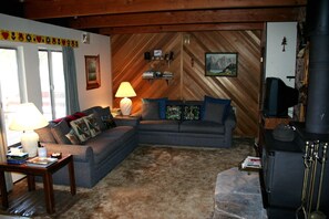 Relax in this inviting living room with a sectional sofa, side table, and fireplace.