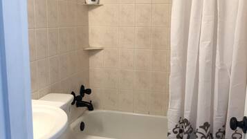 Ein Badezimmer mit Toilette, Waschbecken und Badewanne.