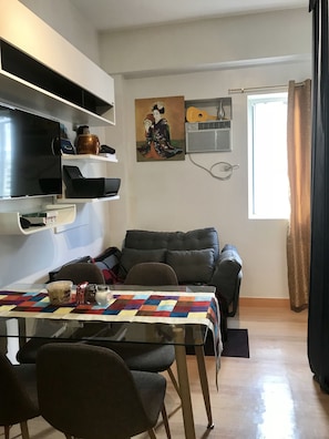 Cozy living space with a dining area, flat-screen TV, and comfortable seating area.