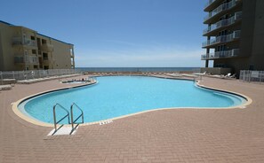 A swimming pool with a 5 ft depth marker, surrounded by lounge chairs and a view of the ocean. - *Wonderful Views!* Gulf Front! Aug 15 - 19th open! (Panama City Beach)