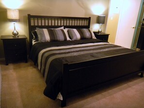 A standard hotel room with a single bed, two bedside tables, and two wall-mounted lamps. - Look at This, too! Fun in the Sun for Everyone! (Kissimmee)