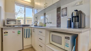 A compact kitchen with a toaster, kettle, coffee maker, and a microwave. - Riverside Studio, Minnamurra, South Coast (Minnamurra)