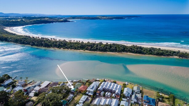An aerial view of a coastal area with a marina, beach, and residential buildings. - Riverside Studio, Minnamurra, South Coast (Minnamurra)