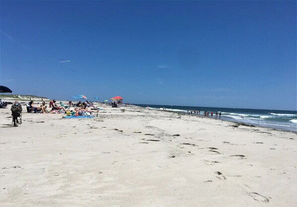 Enjoy a serene beach experience with calm seas and gentle waves.