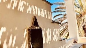 A building with multiple small, triangular openings in the wall, likely for ventilation or decoration. - ⭐️⭐️⭐️⭐️⭐️AMAZING BEACH HOUSE in TINOS! Literally On the Beach!  (Tinos)