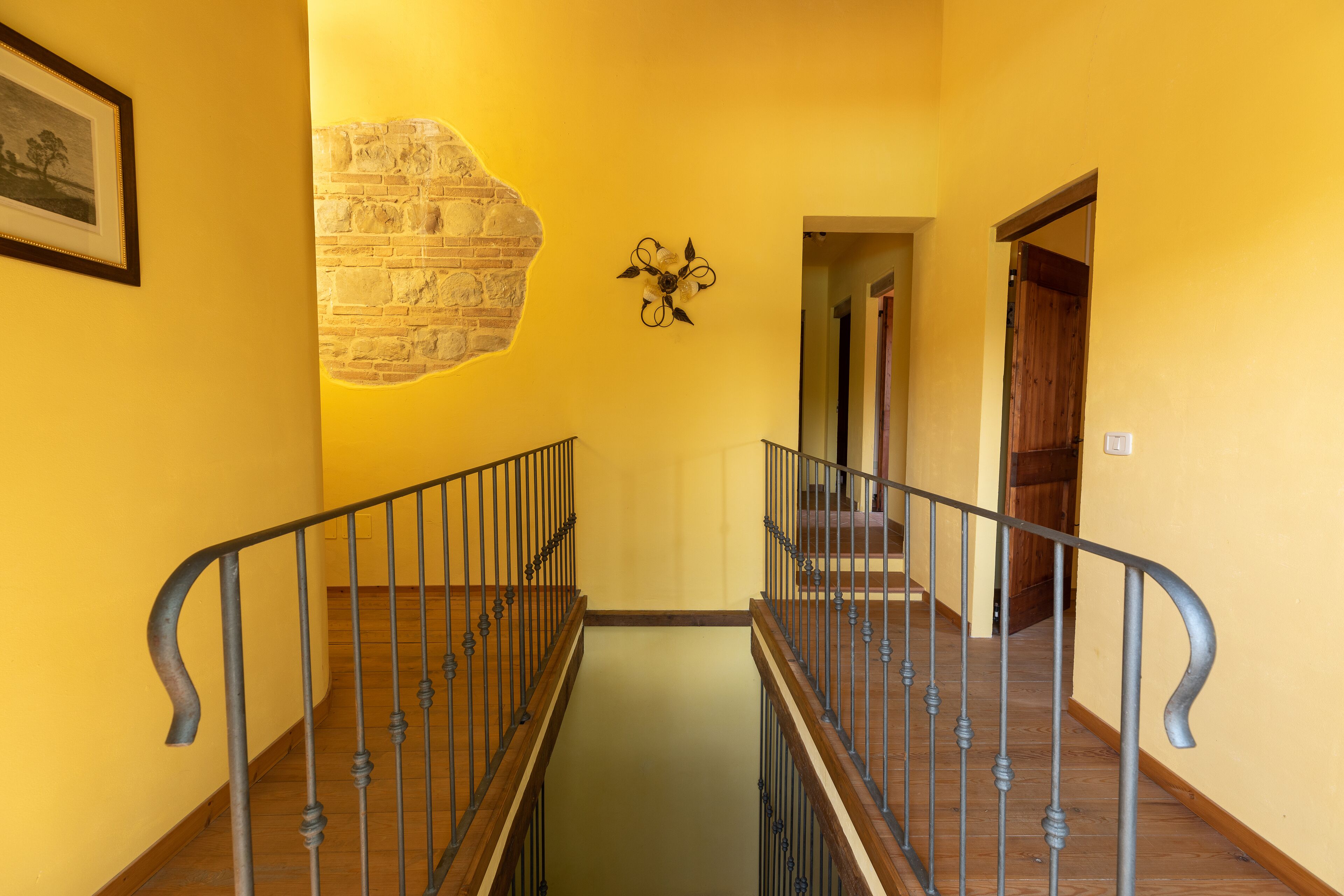 A staircase with a brick wall and a flower decoration.