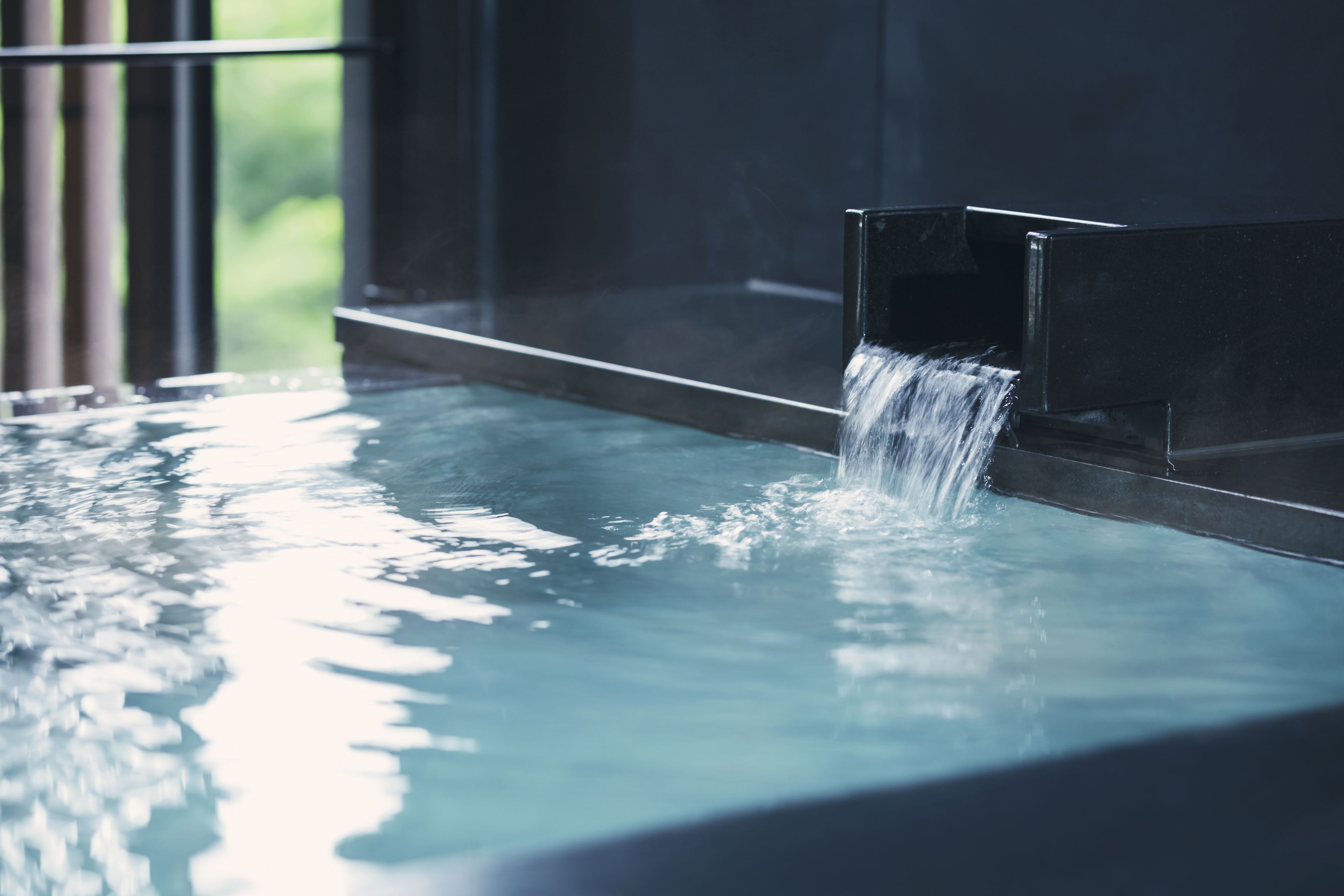 Un élément décoratif aquatique composé d’un ruisseau se jetant dans un bassin.