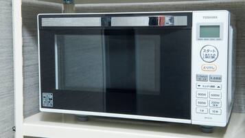 Un four à micro-ondes Toshiba doté d’un écran numérique, de réglages de puissance et de différentes options de minuterie.