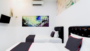 A hotel room with two beds, a flat-screen TV, and a large abstract painting on the wall. - Hotel O Jalan Jenderal Sudirman Near Imam Bonjol Square Formerly Nelvi Guest House (Padang)
