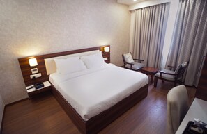 Deluxe Room | Desk, laptop workspace, blackout curtains, soundproofing - Sai Maa Hotel and Residency (Puttaparti)