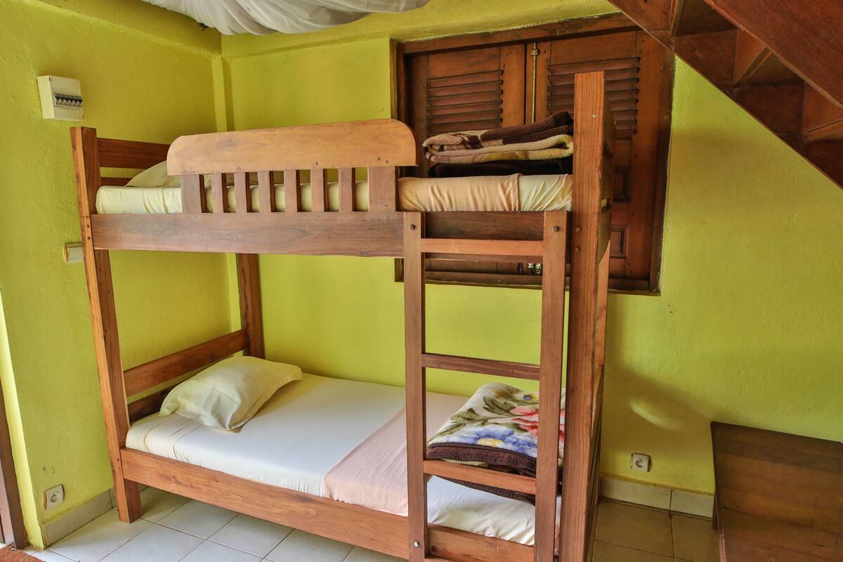 Ein Stockbett mit Holzbettgestell und einer Matratze.