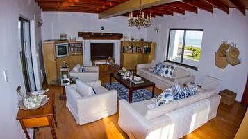 Panoramic House, 5 Bedrooms, Non Smoking, Beach View | Living area | Flat-screen TV, fireplace, DVD player