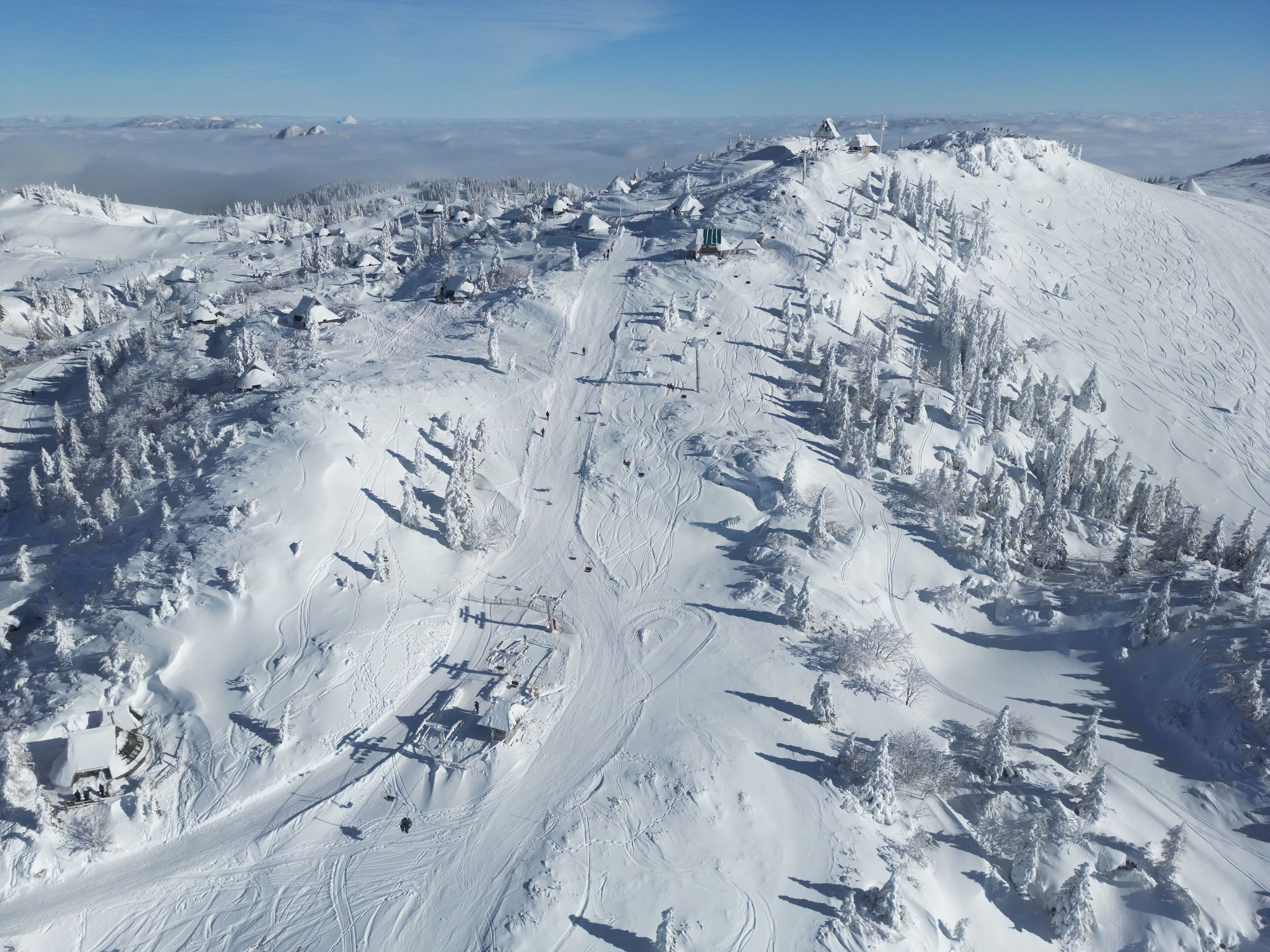 Pista de esquí cubierta de nieve, con telesillas y senderos.