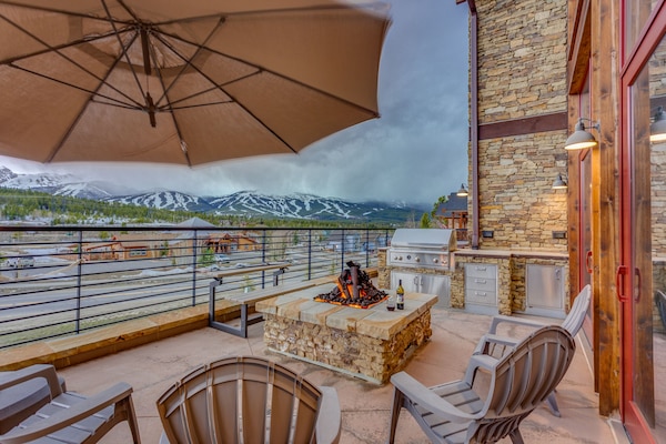 Massive west-facing home-wide patio that is the jewel of the home. Sit around an iron-log gas fireplace with a glass of wine. Grill some steaks while gazing at the mountains on the gourmet grill, or relax in the large modern hot tub.