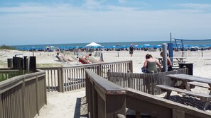 A beach with wooden walkways, beach chairs, umbrellas, and a white tent. - Blufton, Hilton Head Is SC. Vacation home. 3BR. 2BA Sleeps 6. 1 Night Min Stay. (Bluffton)