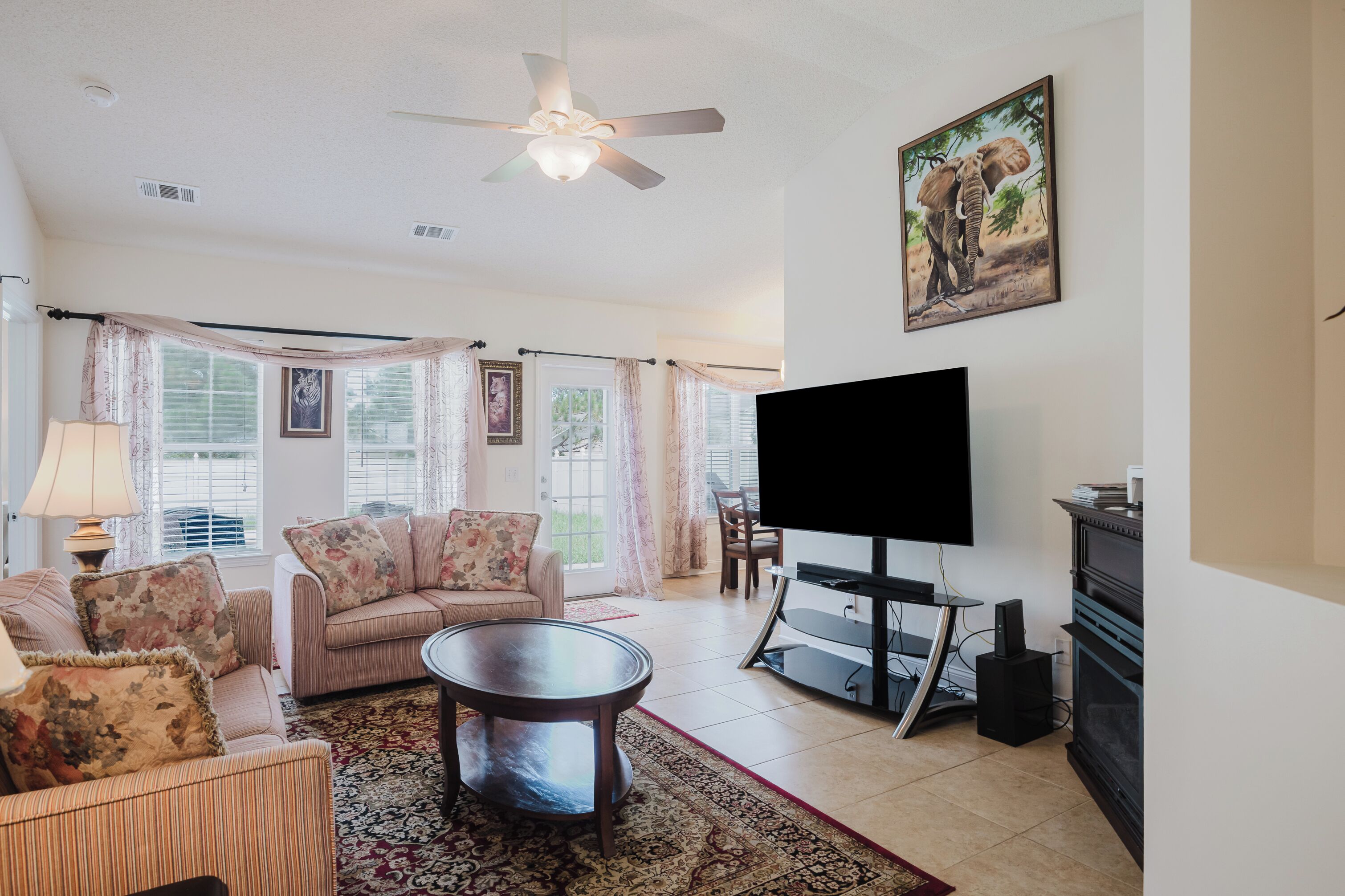 A living room with a sofa, coffee table, TV, and fireplace.