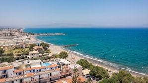 A coastal town with buildings along the beach and a clear view of the sea. - Sun Ray Luxury Apartments (Chania)