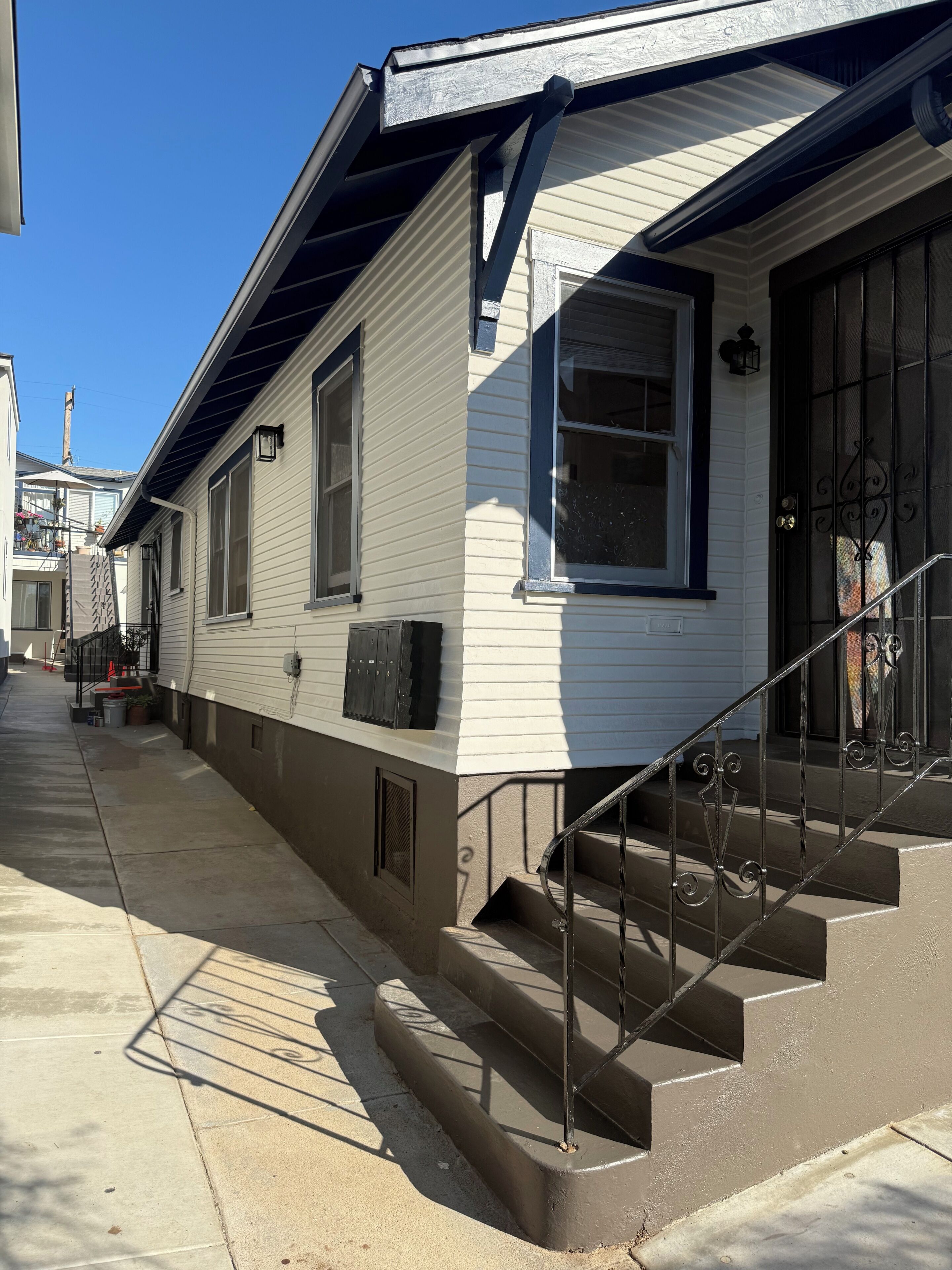A two-story house with a front porch, a staircase, and a garage.