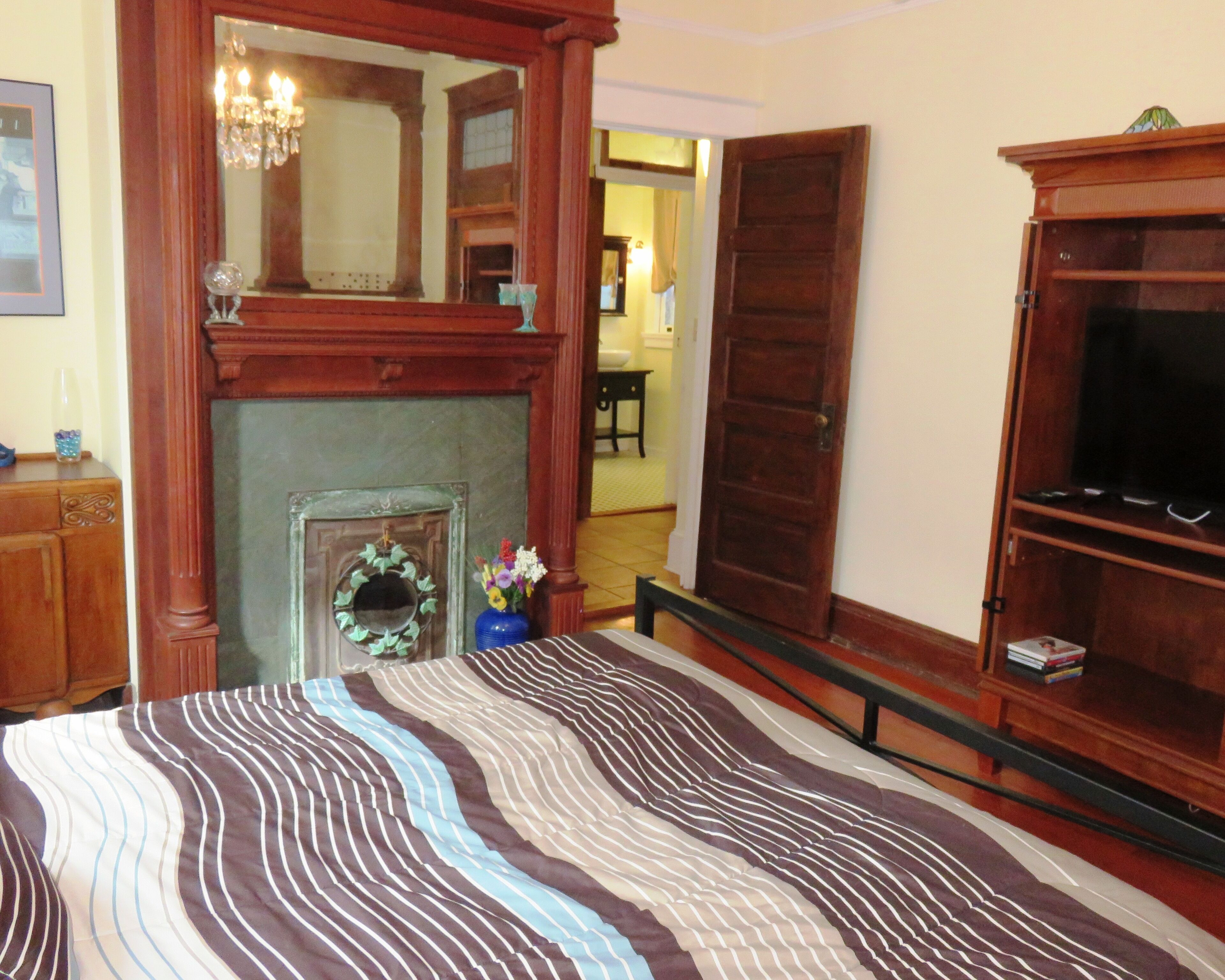 Antique Decorative Fireplace in Bedroom.  View to the bathroom.