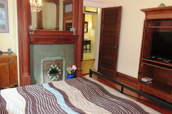 Antique Decorative Fireplace in Bedroom. View to the bathroom.