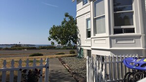 A coastal house with a white picket fence, a bicycle, and a view of the sea. - Amazing sunset in front of historic house  (Blaine)