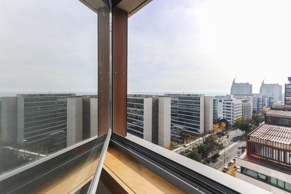 A high-rise building with a view of the cityscape through a window. - Expo Panoramic View by Homing (Lisbon)