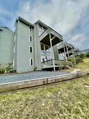 A multi-story building with a balcony and a covered walkway.