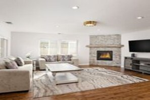 Spacious living room with fireplace 
and large flat screen TV