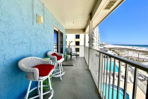 Enjoy breathtaking views of the beach and pool from this balcony.