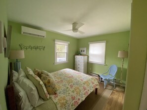 A bedroom with a bed, dresser, chair, and a ceiling fan. - Walk to beach , bay , shopping & restaurants , Sunset Views at end of our st 1 (Harvey Cedars)