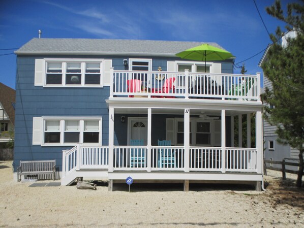 A two-story house with a balcony, a porch, and a visible number '11' on the house. - Walk to beach , bay , shopping & restaurants , Sunset Views at end of our st 1 (Harvey Cedars)