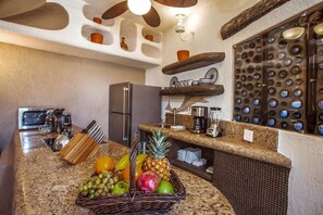 Enjoy cooking in this well-equipped kitchen with a granite countertop, stainless steel appliances, and a coffee machine.