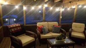 An outdoor seating area with wicker chairs and a sofa, string lights, and a view of a snowy landscape. - Lake Cumberland Hideaway #1-2 miles from Jtown Marina! Boat Parking & Fire Pit! (Jamestown)
