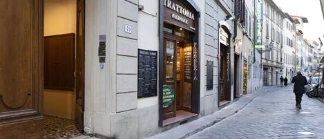 A street view of a building with a sign reading "Trattoria Nerone" indicating a restaurant.