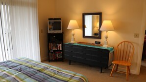A bedroom with a bed, a dresser, a chair, a bookshelf, and a television. - 2B Condo w/ Game Tables and Great Views! (Sugar Mountain)