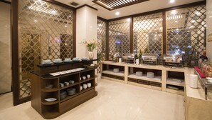 A buffet setup with various dishes and serving ware. - Western Hanoi Boutique Hotel (Hanoi)