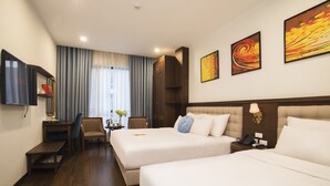 A hotel room with two beds, a desk, a chair, a TV, and artwork on the walls. - Western Hanoi Boutique Hotel (Hanoi)