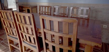 A dining area with wooden chairs and a table.
