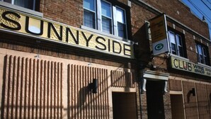 A building with a sign that reads "SUNNYSIDE" and another sign for "CLUB WINE SHOP". - Charming! Near Microsoft Mt Pleasant - Sleeps 8 (Kenosha)