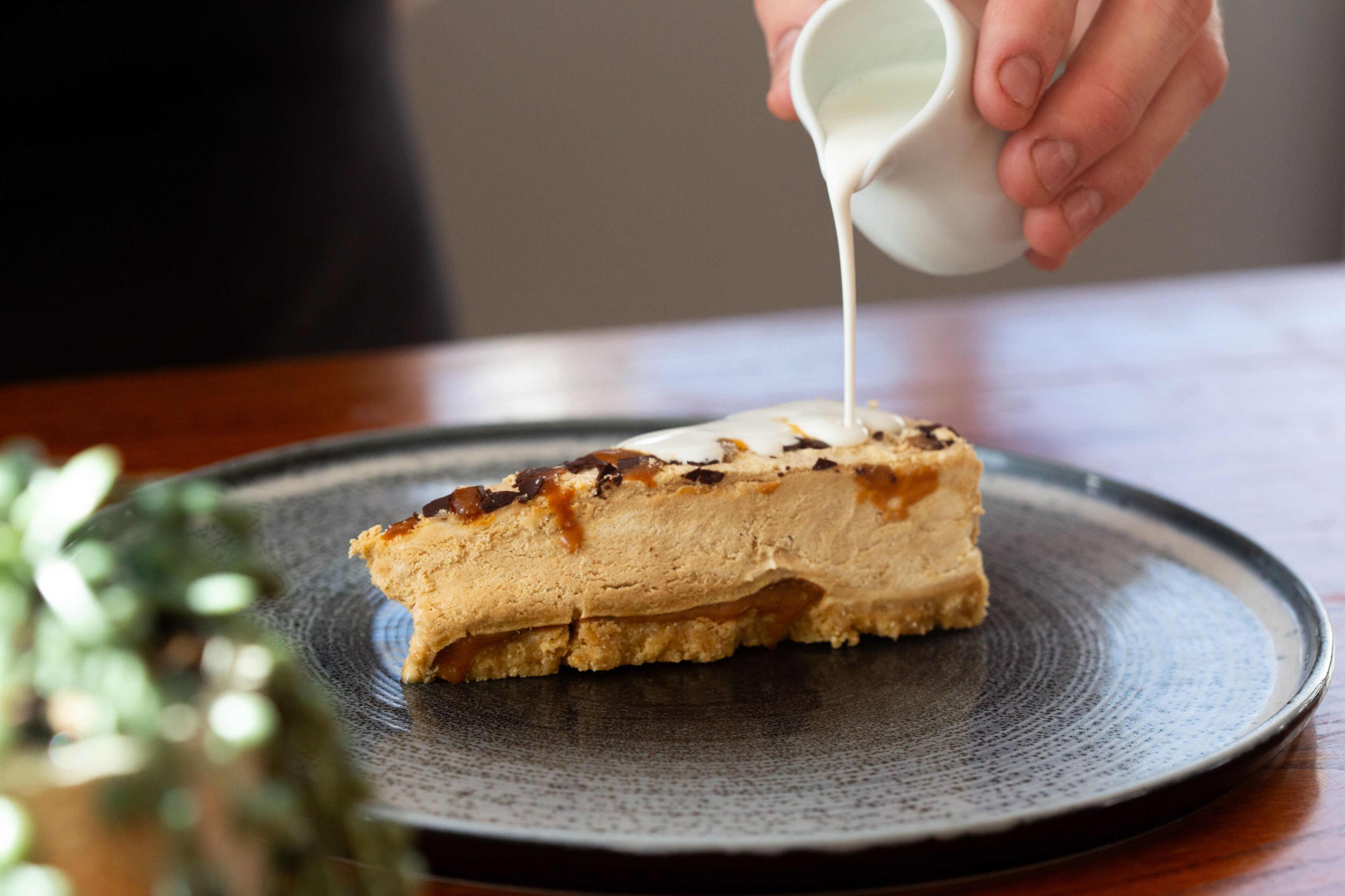 A slice of layered dessert on a plate.