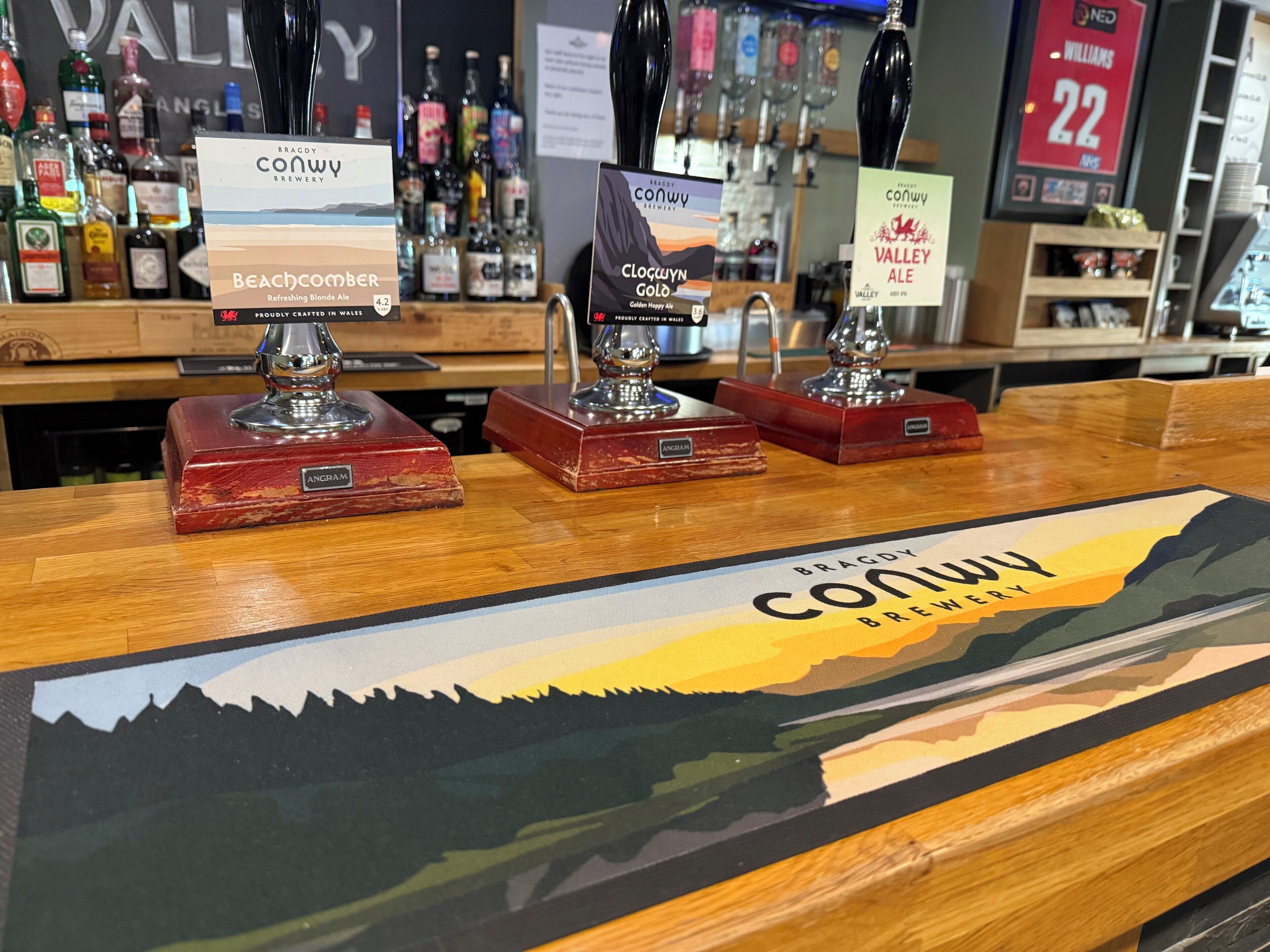A bar area with three beer taps labeled 'Beachcomber', 'Cloquyn Golo', and 'Valley Ale'.