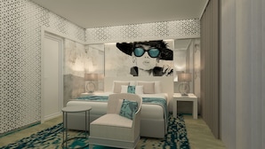 A modern bedroom with a large bed, a small table, two bedside tables, and a decorative wall mural. - Europe Hotel & Casino (Sunny Beach)