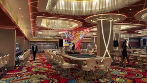 A spacious casino with a vibrant carpet, multiple gaming tables, and a modern chandelier. - Europe Hotel & Casino (Sunny Beach)