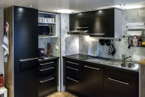 City appartement, 2 slaapkamers, uitzicht op de binnenplaats | Privékeuken | Een koelkast met diepvriezer, een microgolfoven, een oven, een kookplaat